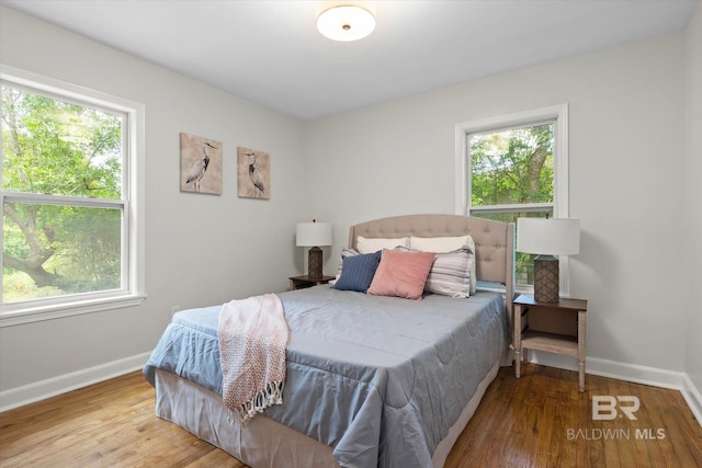 3512 Spring Hill Ave, Mobile, AL 36608 - bedroom featuring multiple windows and wood finished floors