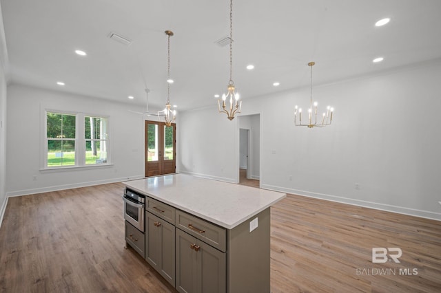 12380 Mannich Ln, Foley, AL 36580 - kitchen featuring gray cabinetry, open floor plan, a chandelier, recessed lighting, and oven