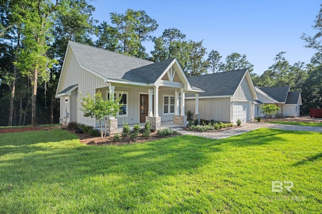 12380 Mannich Ln, Foley, AL 36580 - craftsman house featuring roof with shingles, a porch, and a front yard