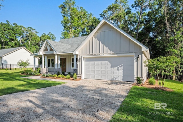 12380 Mannich Ln, Foley, AL 36580 - view of front facade with board and batten siding, driveway, covered porch, an attached garage, and a shingled roof