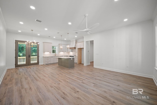 12380 Mannich Ln, Foley, AL 36580 - kitchen with open floor plan, a center island, a sink, tasteful backsplash, and light wood finished floors