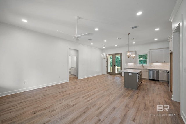 12380 Mannich Ln, Foley, AL 36580 - kitchen with dishwasher, open floor plan, a kitchen island, recessed lighting, and tasteful backsplash