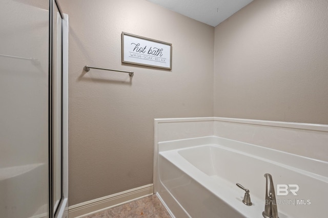 bathroom with a tub to relax in