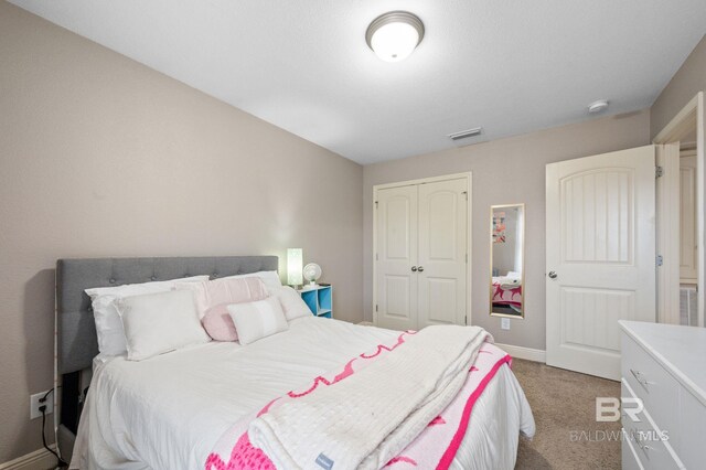 carpeted bedroom featuring a closet