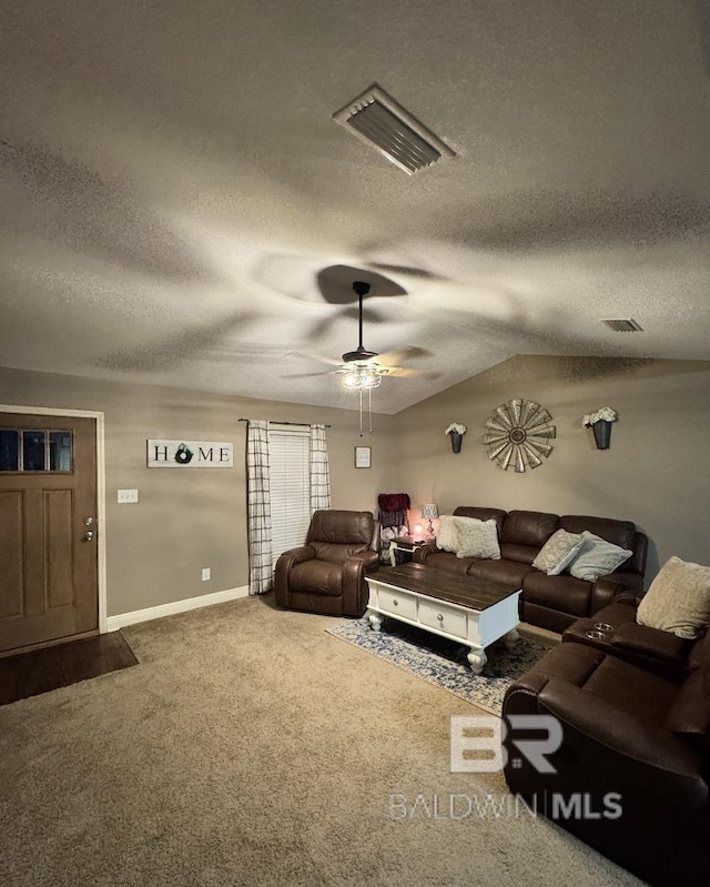 living room with carpet floors, ceiling fan, and a textured ceiling