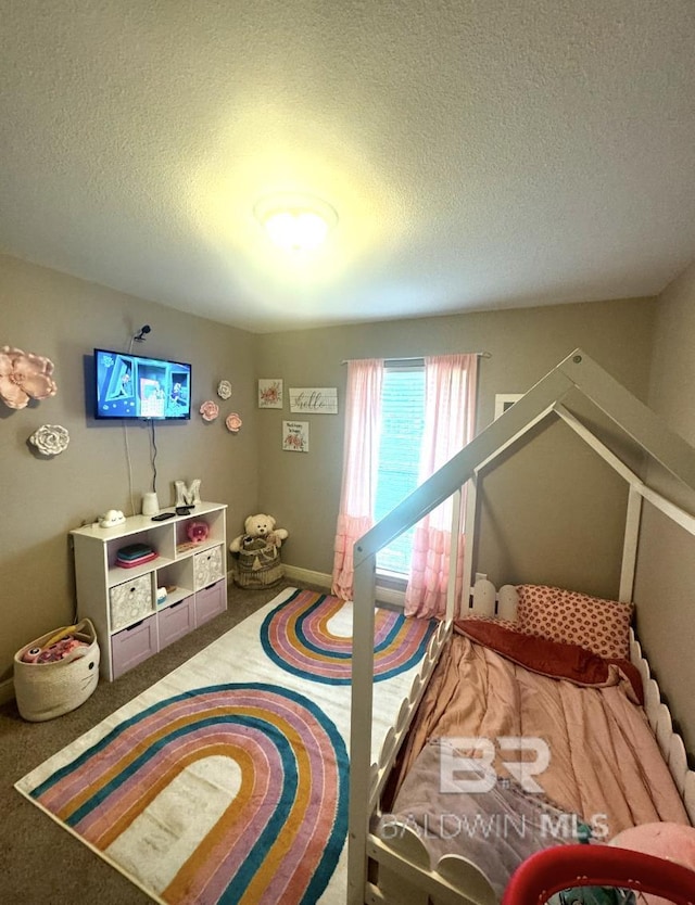 bedroom featuring a textured ceiling and carpet