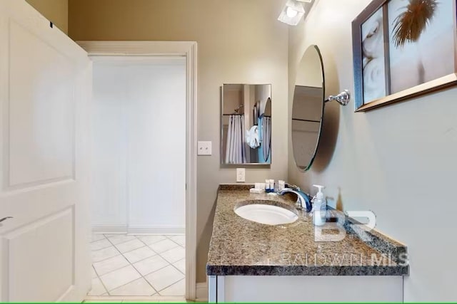 bathroom with tile patterned flooring and vanity