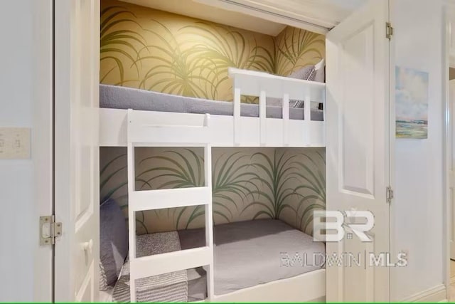 bedroom with wallpapered walls