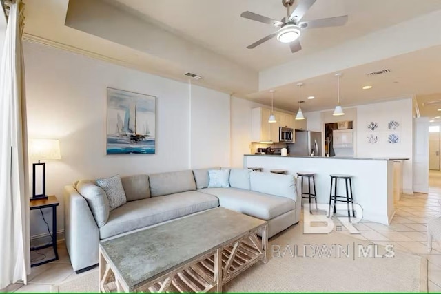 living area featuring light tile patterned floors, ceiling fan, and visible vents