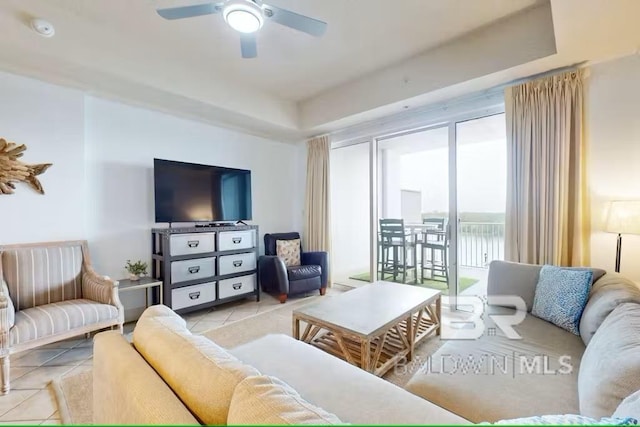 tiled living room with a ceiling fan