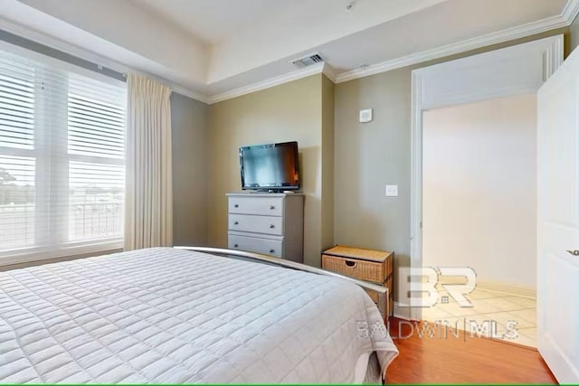 tiled bedroom featuring baseboards, visible vents, and crown molding