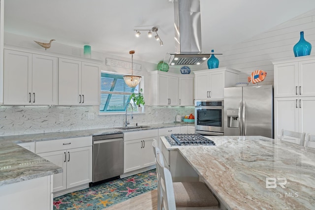 kitchen featuring island range hood, sink, white cabinets, a kitchen bar, and stainless steel appliances