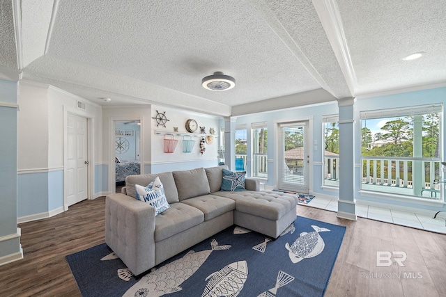 living room with hardwood / wood-style flooring, ornamental molding, and a wealth of natural light