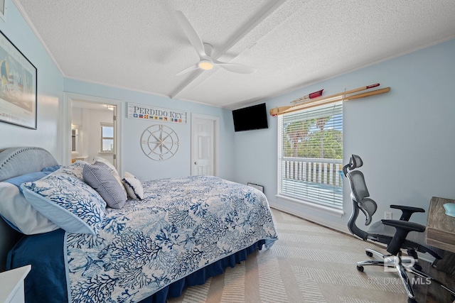 bedroom with ceiling fan, light colored carpet, and a textured ceiling