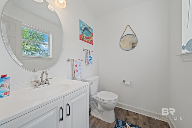 bathroom featuring vanity, wood-type flooring, and toilet