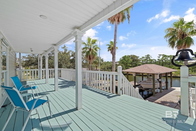 wooden deck featuring a water view and a dock