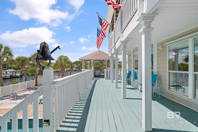 deck featuring a gazebo and a water view