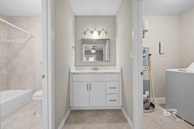 full bathroom featuring washer / dryer, tiled shower / bath, toilet, vanity, and tile patterned floors