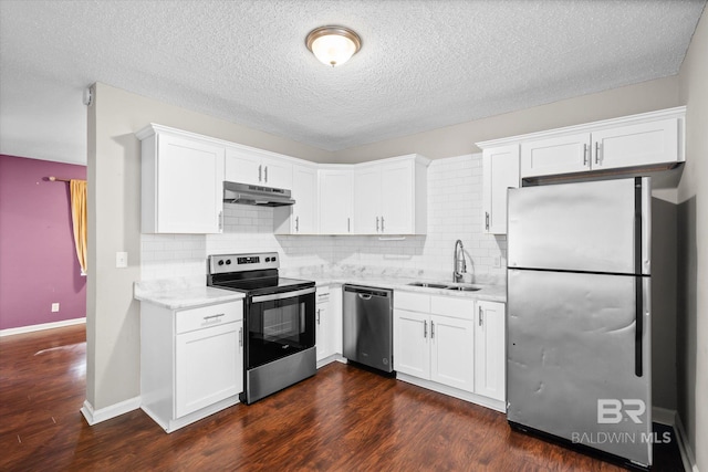 kitchen with stainless steel appliances, dark hardwood / wood-style floors, and white cabinets