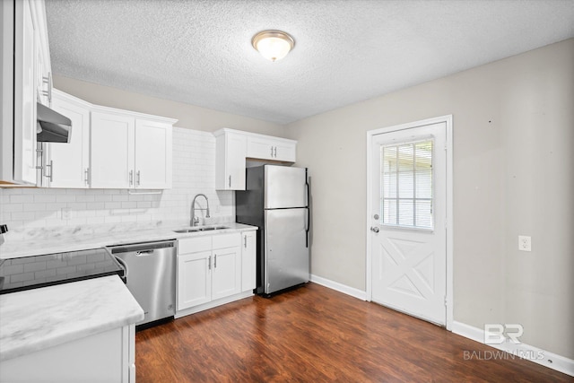 kitchen featuring sink, backsplash, dark hardwood / wood-style flooring, white cabinetry, and stainless steel appliances