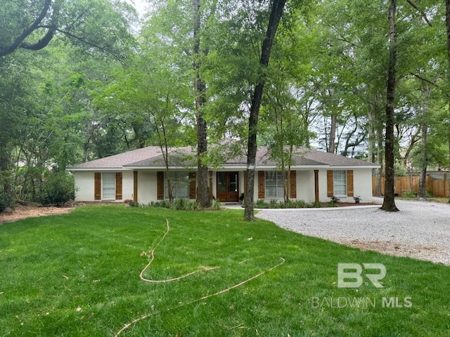 ranch-style home featuring a front yard