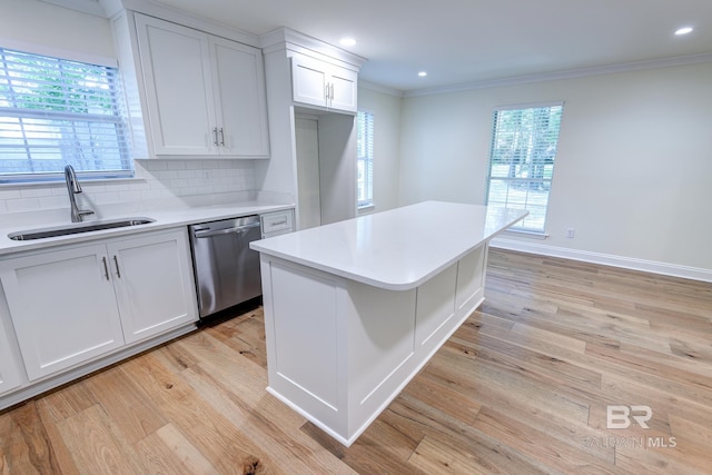 kitchen featuring dishwasher, sink, plenty of natural light, and light hardwood / wood-style floors