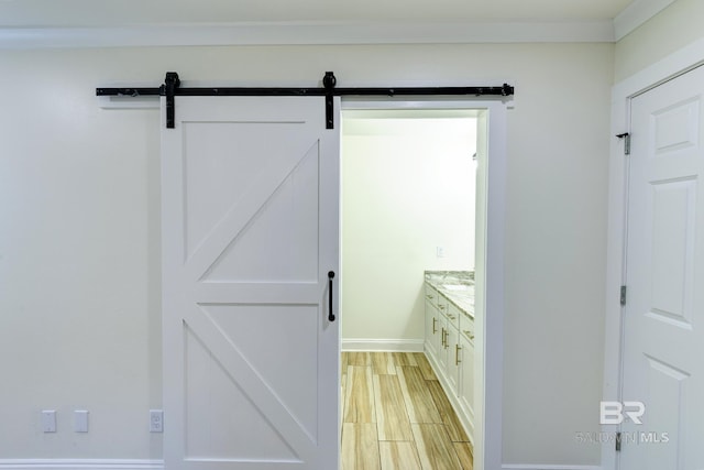 bathroom with hardwood / wood-style flooring, ornamental molding, and vanity