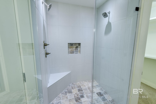 bathroom featuring a shower with shower door