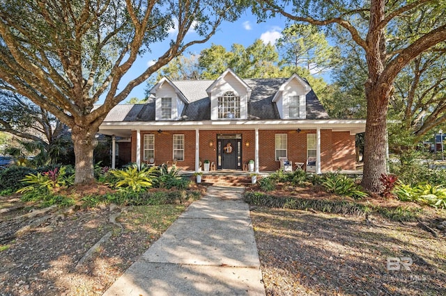 new england style home featuring a porch