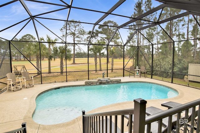 view of pool featuring a patio area, pool water feature, and glass enclosure