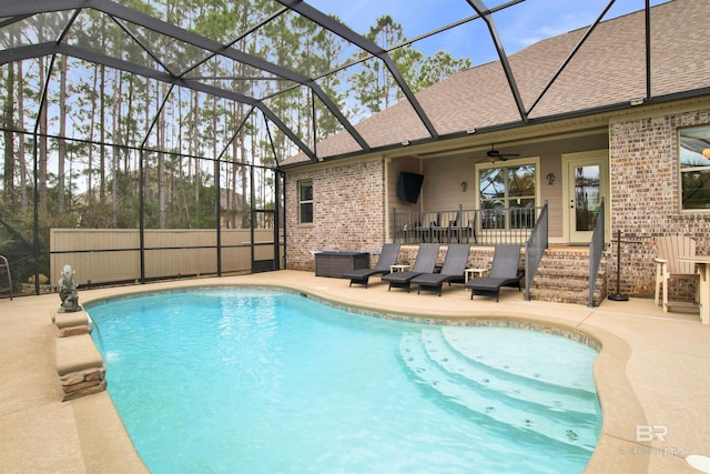 view of pool featuring ceiling fan, a lanai, and a patio