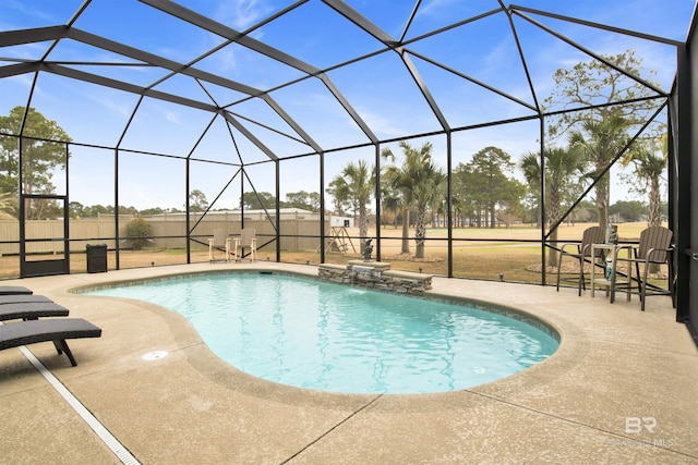 view of swimming pool featuring pool water feature, a lanai, and a patio area