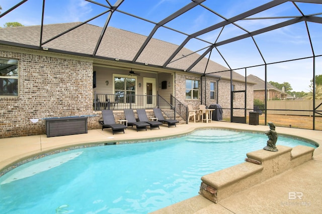 view of pool featuring a patio, ceiling fan, and glass enclosure