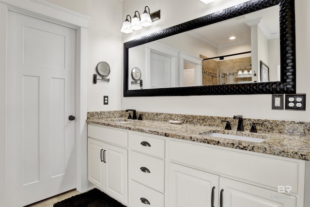 bathroom with ornamental molding, vanity, and a shower