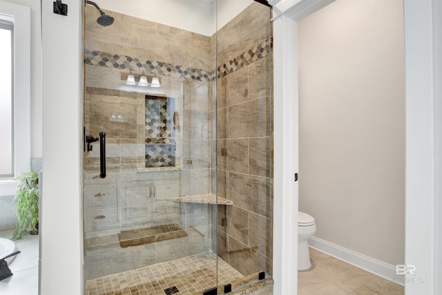 bathroom with a shower with door, tile patterned floors, and toilet