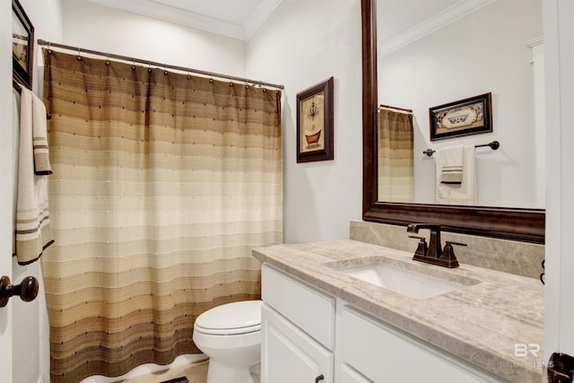 bathroom with ornamental molding, vanity, and toilet