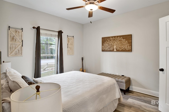 bedroom with ceiling fan and light hardwood / wood-style floors