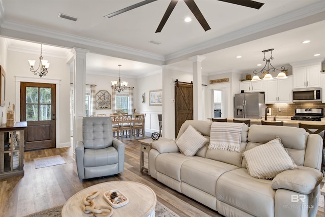 living room with ornamental molding, hardwood / wood-style floors, and plenty of natural light