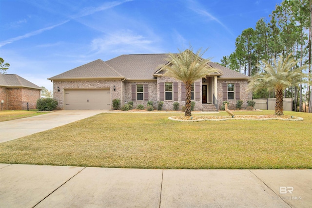 view of front of property featuring a garage and a front yard