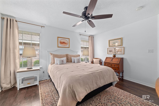 bedroom with ceiling fan, dark hardwood / wood-style floors, and a textured ceiling