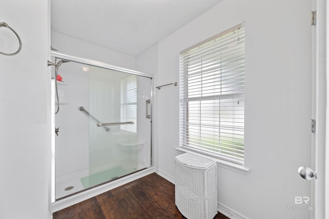 bathroom featuring an enclosed shower and hardwood / wood-style floors