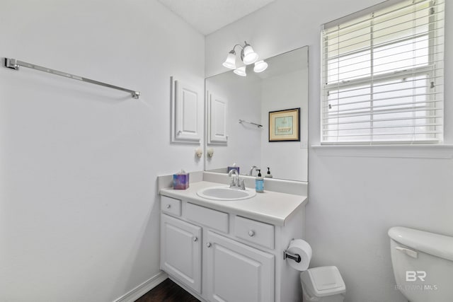 bathroom featuring vanity and toilet