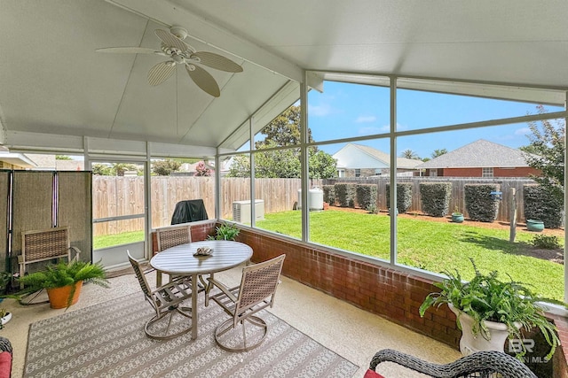 sunroom featuring plenty of natural light, lofted ceiling with beams, and ceiling fan