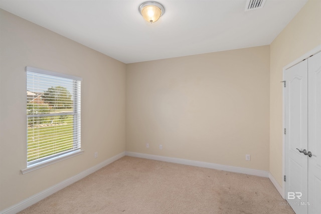 empty room with light colored carpet