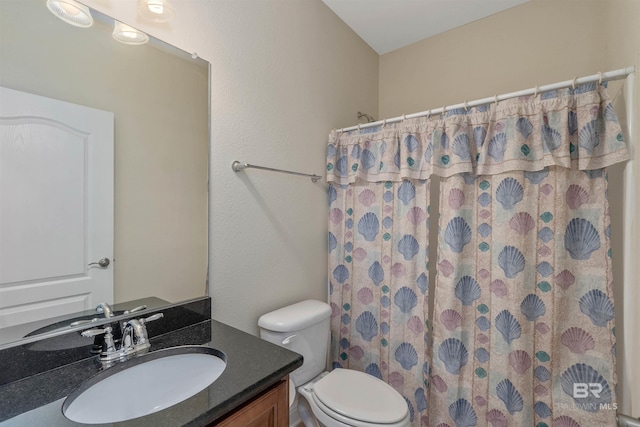 bathroom with vanity, toilet, and curtained shower