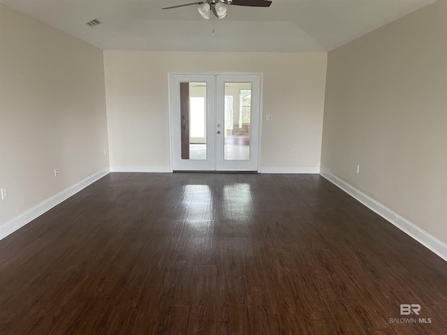 spare room with french doors, dark wood-style flooring, visible vents, and baseboards