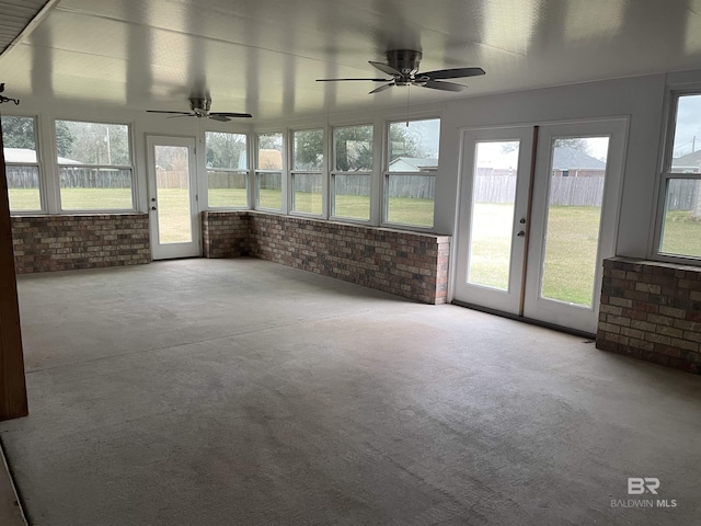 unfurnished sunroom featuring french doors and a ceiling fan