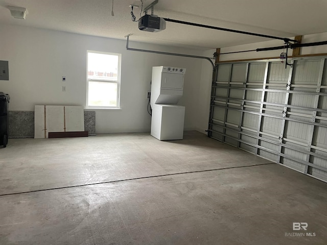 garage with stacked washing maching and dryer, electric panel, and a garage door opener