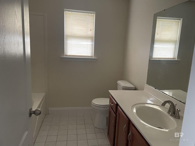 bathroom with baseboards, toilet, a tub, tile patterned floors, and vanity