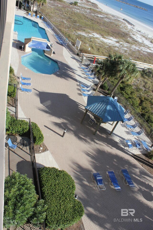 bird's eye view featuring a view of the beach and a water view